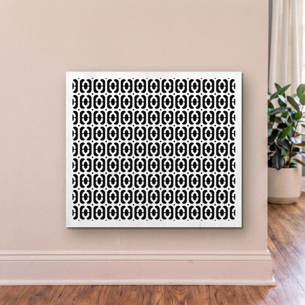 Framed artwork with a black geometric pattern on a white background, displayed on a wall.