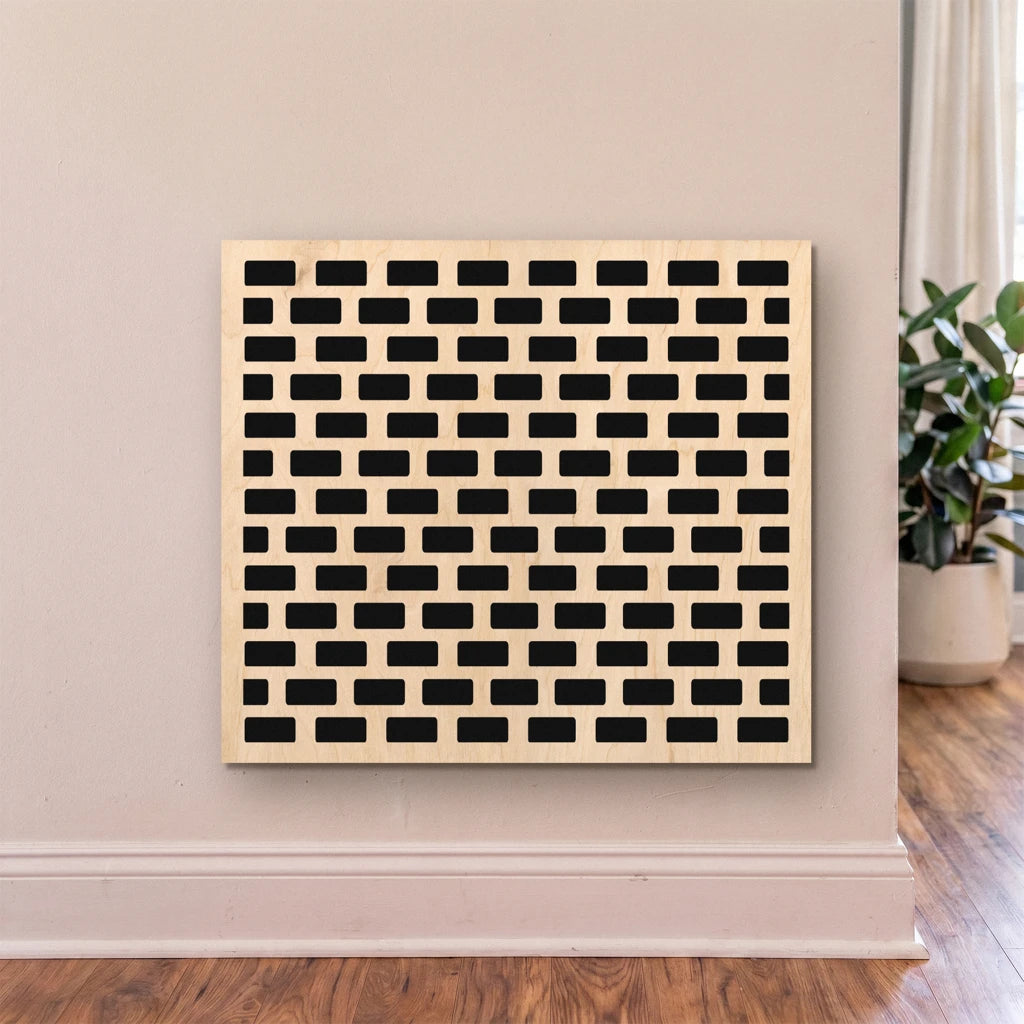 Decorative wall art with geometric pattern on a beige wall.