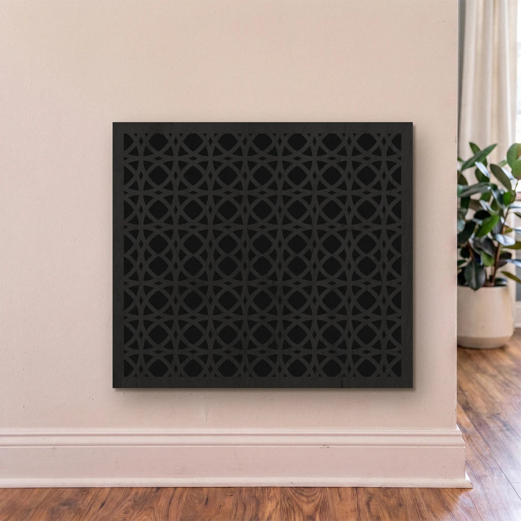 Decorative black panel on a wall with a plant in the corner