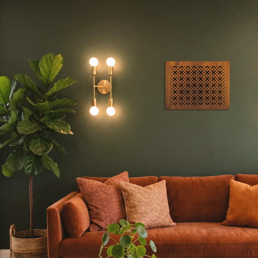 Living room with a brown sofa, decorative pillows, and wall sconces.
