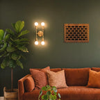 Cozy living room with a brown sofa, decorative pillows, and wall sconces.